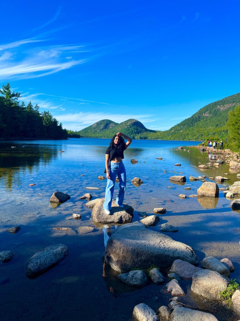 solo traveler at Jordan Pond Acadia National Park Maine with Bubble Mountains in background