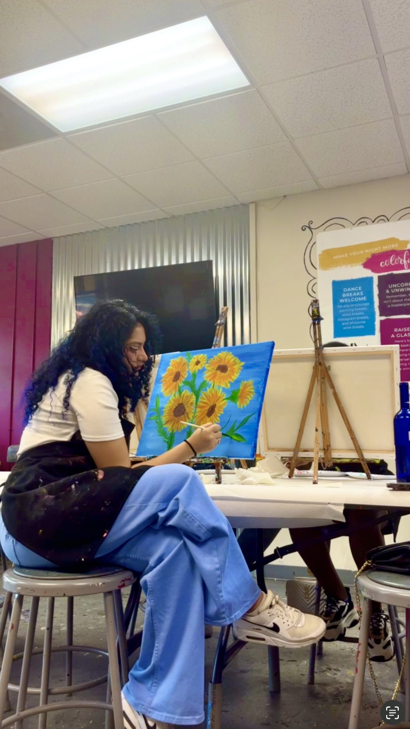 Woman painting alone at a sip and paint class in Savannah Georgia