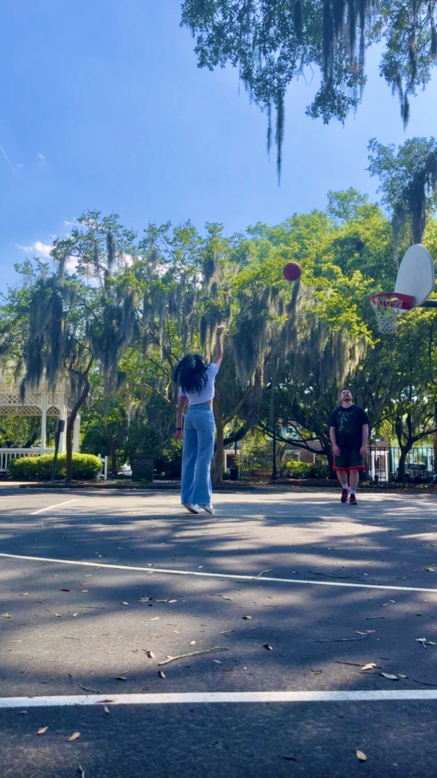Woman playing basketball solo in a park in Savannah Georgia
